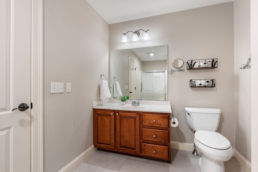 156 Canterbury Way, Unit 156 West Springfield, MA 01089 - Photo 19 of 32 a bathroom with a toilet a sink and mirror