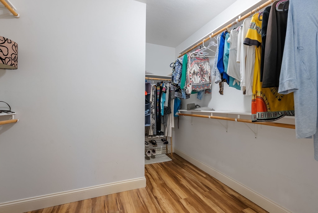 156 Canterbury Way, Unit 156 West Springfield, MA 01089 - Photo 20 of 32 a view of walk in closet with clothes and shoes