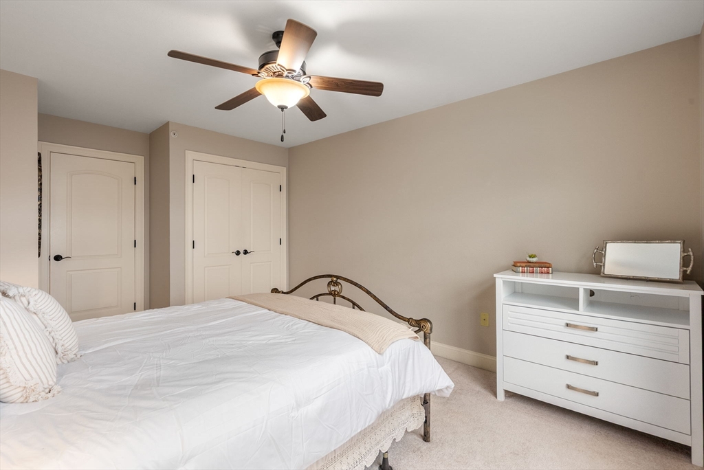156 Canterbury Way, Unit 156 West Springfield, MA 01089 - Photo 22 of 32 a bedroom with a bed and a ceiling fan