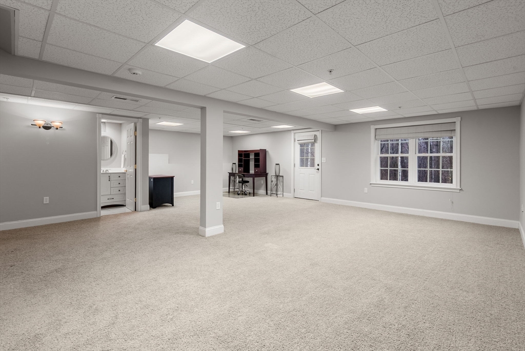 156 Canterbury Way, Unit 156 West Springfield, MA 01089 - Photo 25 of 32 a view of a big room with windows and chandelier fan