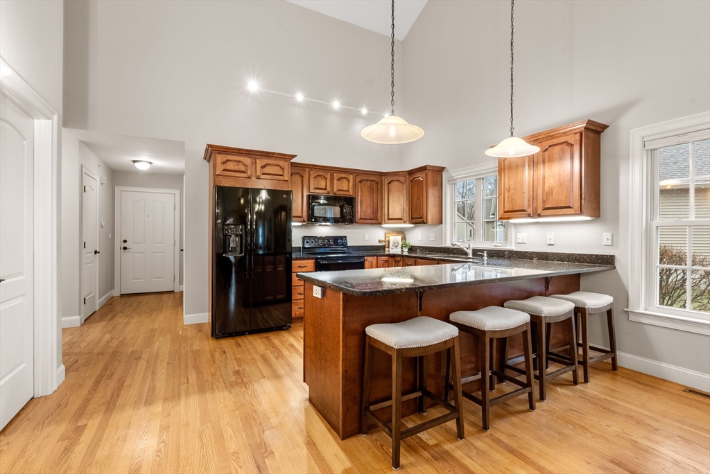 156 Canterbury Way, Unit 156 West Springfield, MA 01089 - Photo 3 of 32 a kitchen with stainless steel appliances granite countertop a refrigerator a sink dishwasher a stove and white cabinets with wooden floor