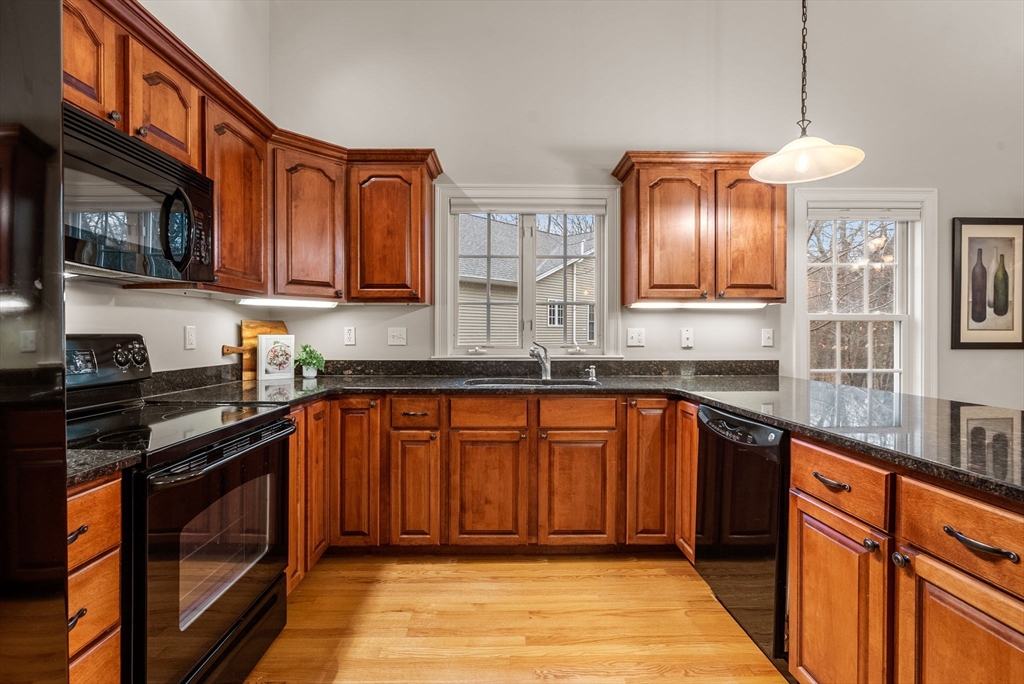 156 Canterbury Way, Unit 156 West Springfield, MA 01089 - Photo 5 of 32 a kitchen with stainless steel appliances granite countertop wooden cabinets a stove top oven a sink and dishwasher