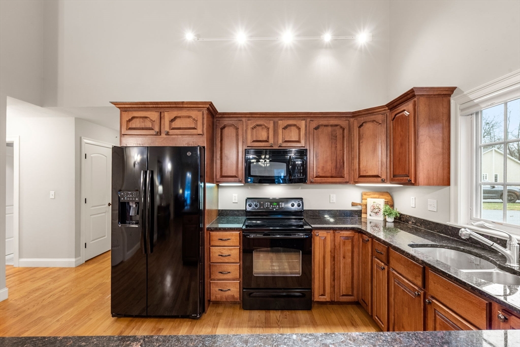 156 Canterbury Way, Unit 156 West Springfield, MA 01089 - Photo 6 of 32 a kitchen with stainless steel appliances granite countertop a refrigerator and a sink