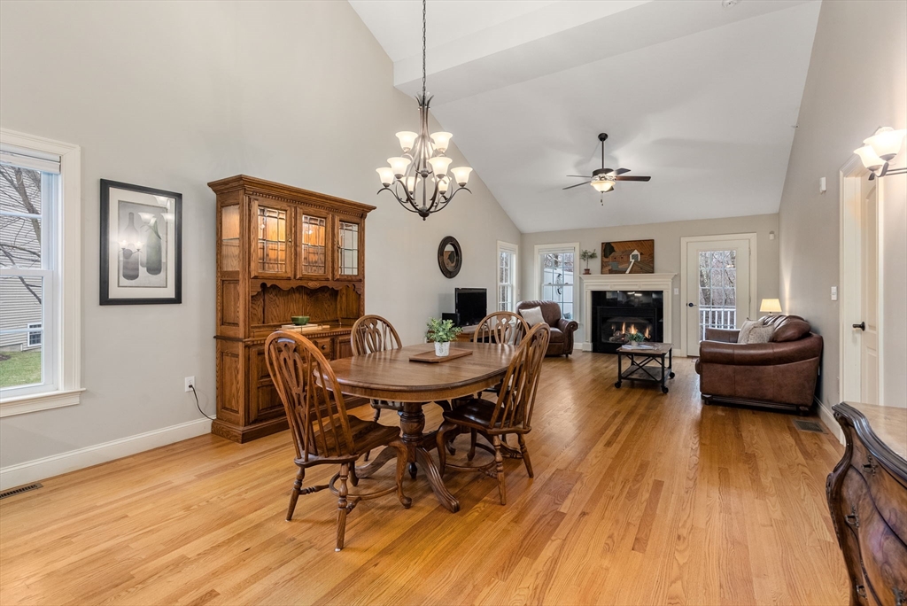156 Canterbury Way, Unit 156 West Springfield, MA 01089 - Photo 10 of 32 a view of a dining room with furniture a chandelier and wooden floor