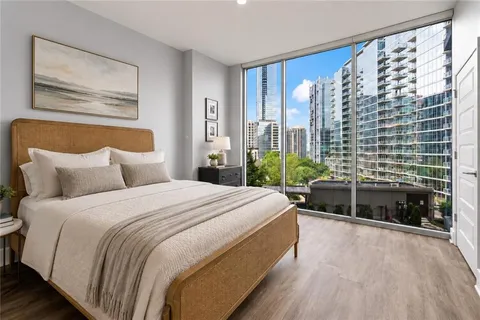 a spacious bedroom with a large bed and a large window