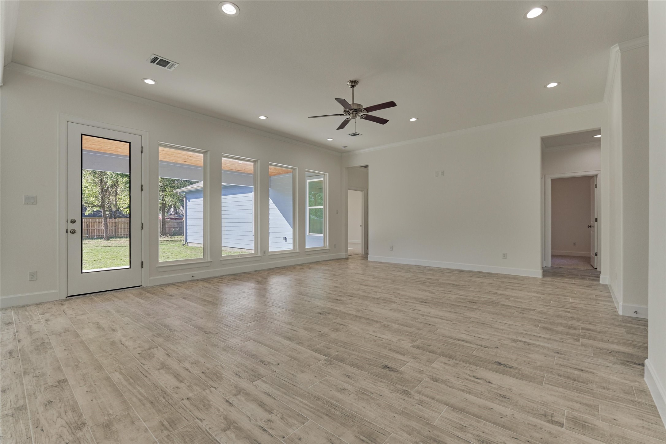 1718 Eastvale Drive Spring, TX 77386 - Photo 13 of 40 a view of an empty room with a window and wooden floor