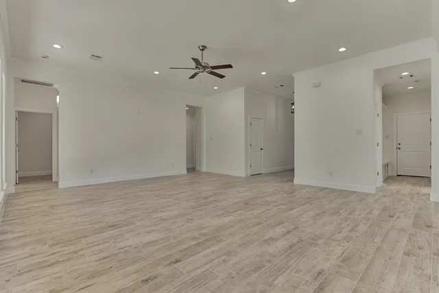 a kitchen with stainless steel appliances granite countertop a sink a stove and a wooden floors