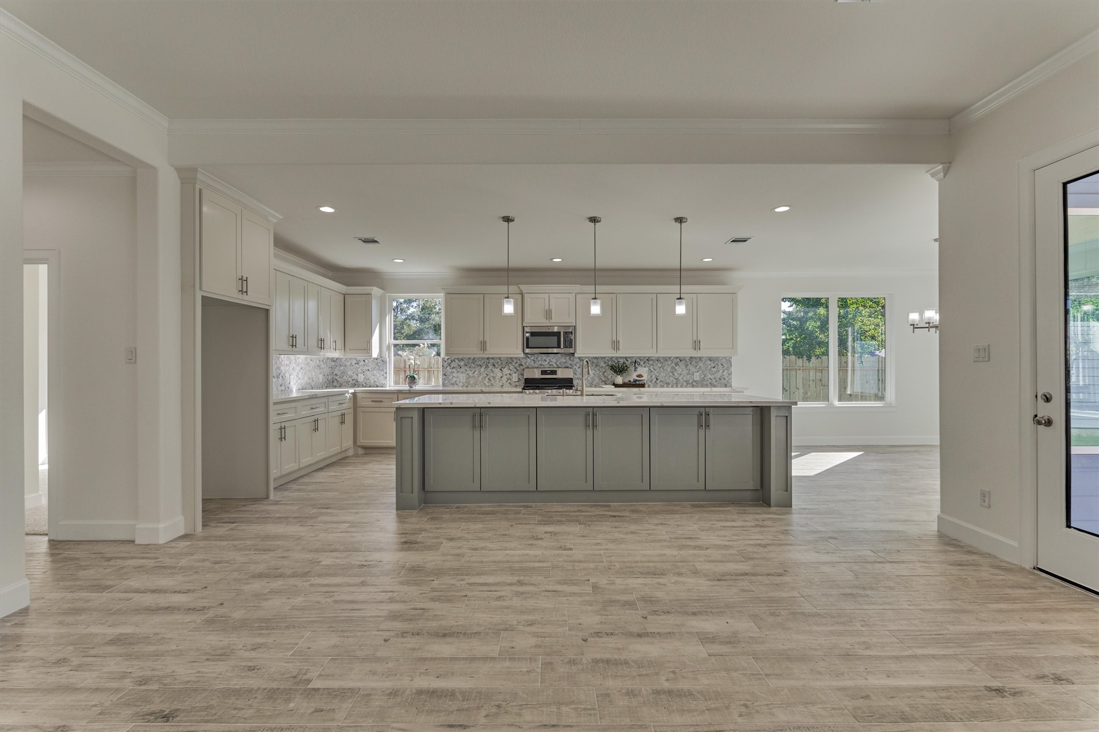 1718 Eastvale Drive Spring, TX 77386 - Photo 17 of 40 a large white kitchen with kitchen island a sink stainless steel appliances and cabinets