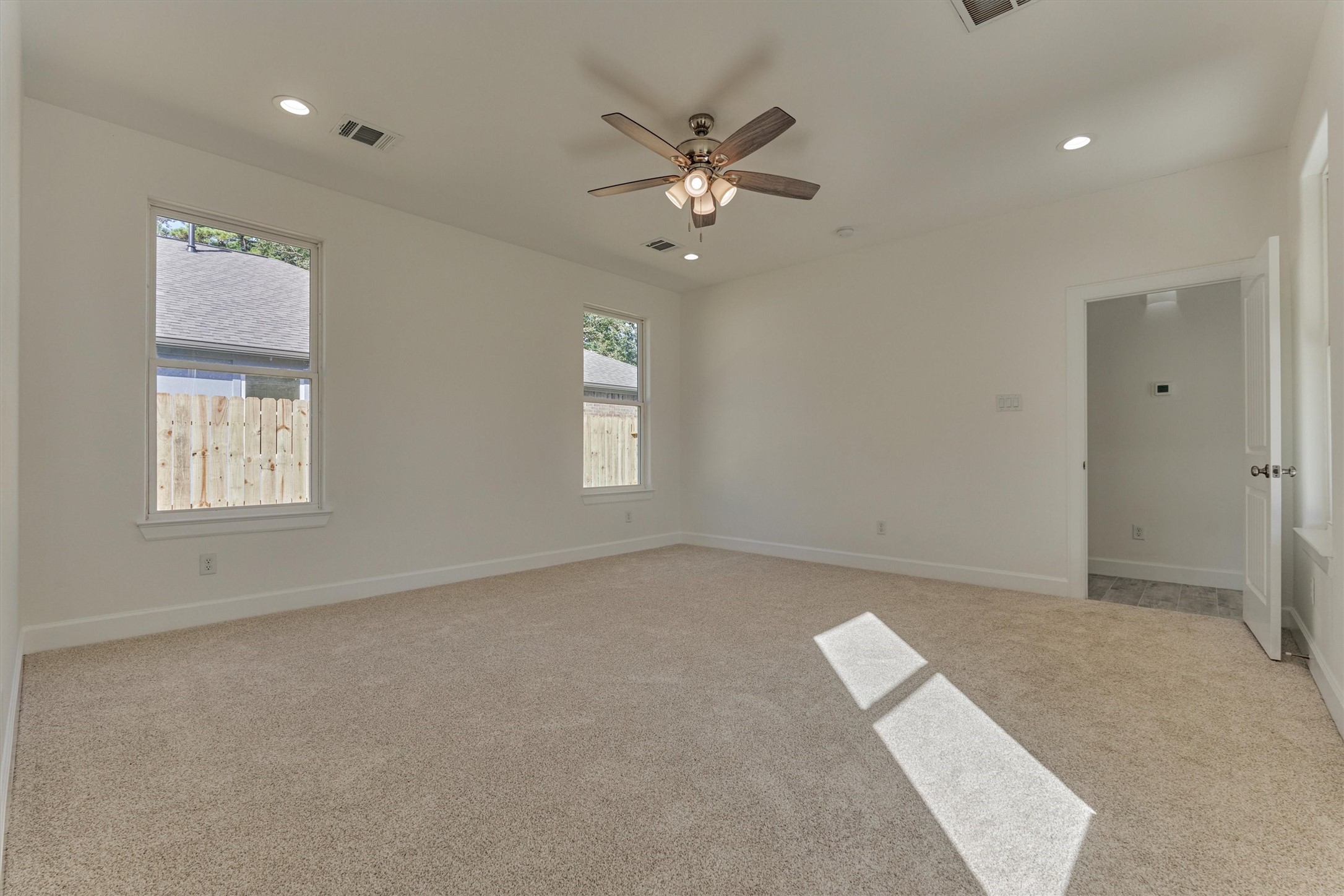 1718 Eastvale Drive Spring, TX 77386 - Photo 19 of 40 an empty room with windows and fan