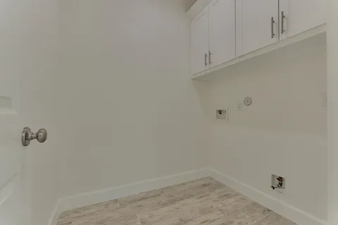 a view of a room with wooden floor