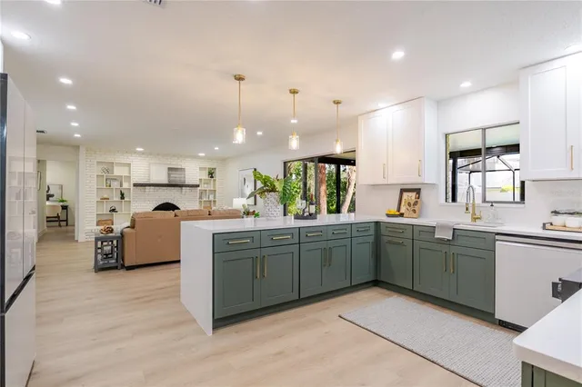 a kitchen with stainless steel appliances granite countertop a sink and stove top oven