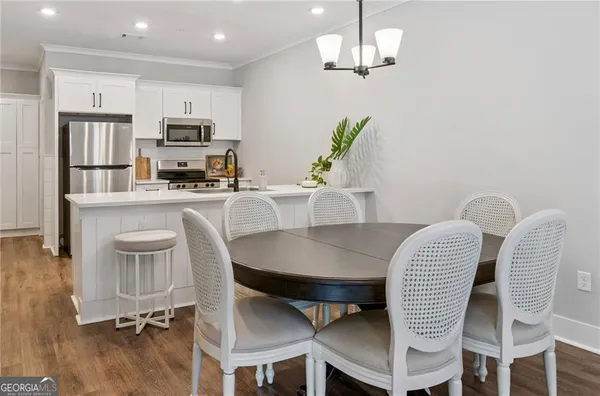 a view of a dining room with furniture and wooden floor