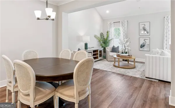 a view of a dining room with furniture and wooden floor