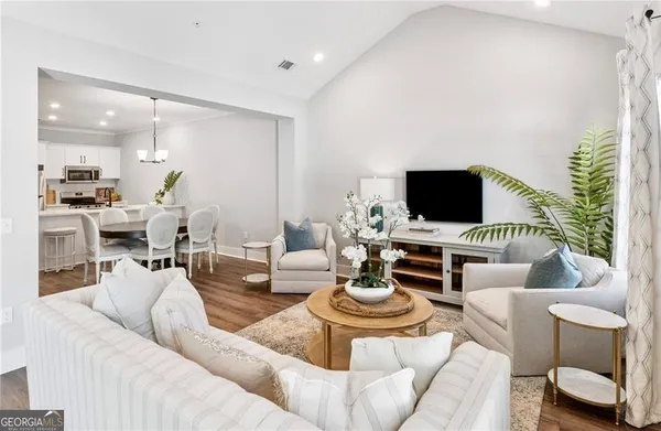 a living room with furniture and a flat screen tv