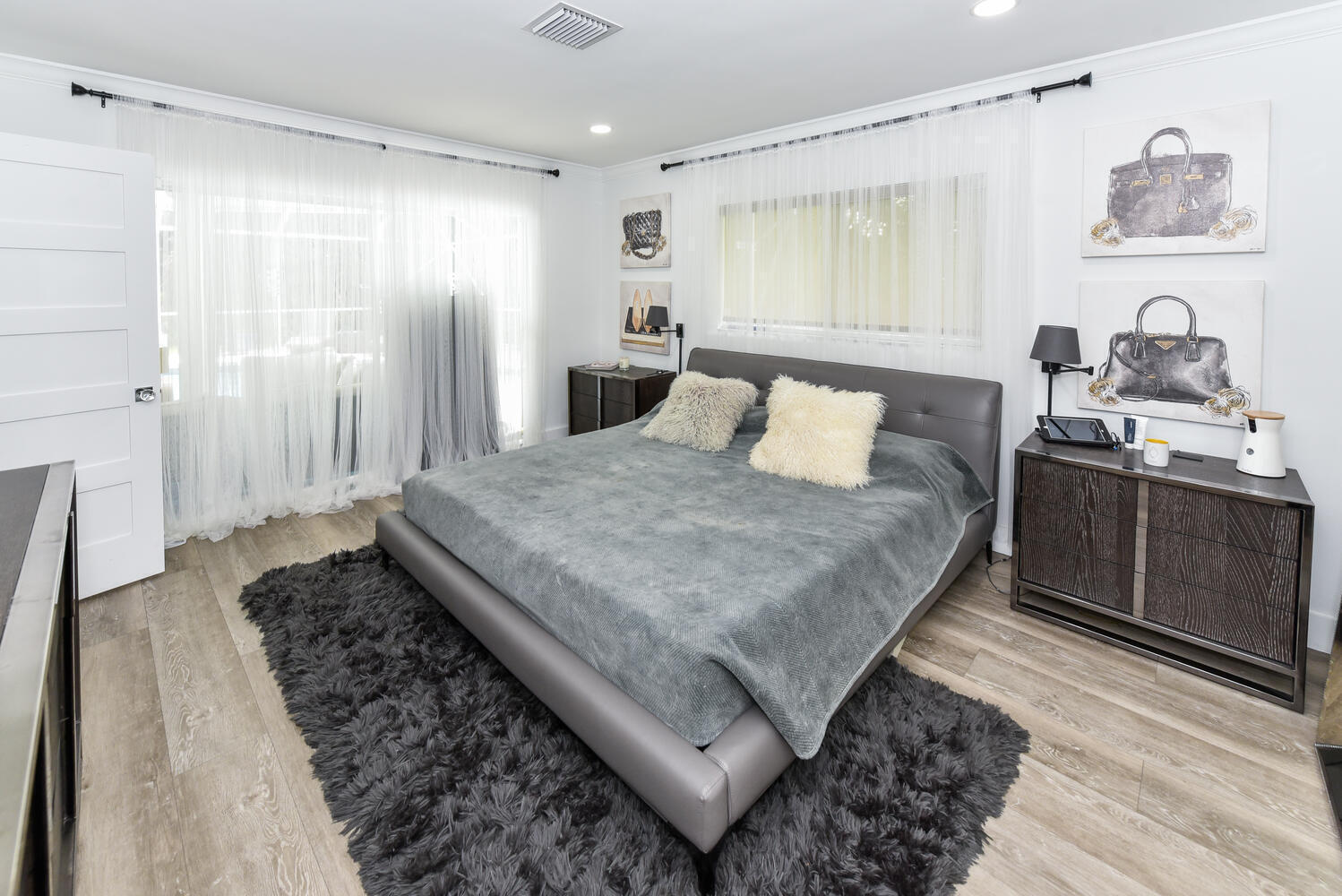 880 Hickory Terrace Boca Raton, FL 33486 - Photo 17 of 38 a large bedroom with a bed and wooden floor