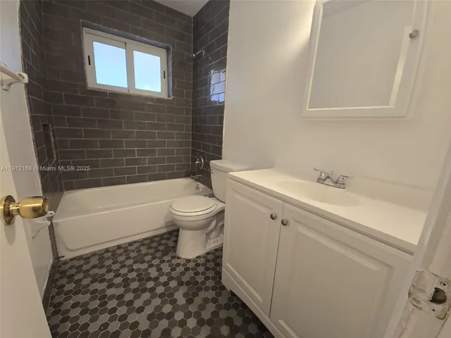 a bathroom with a sink a toilet and a bathtub