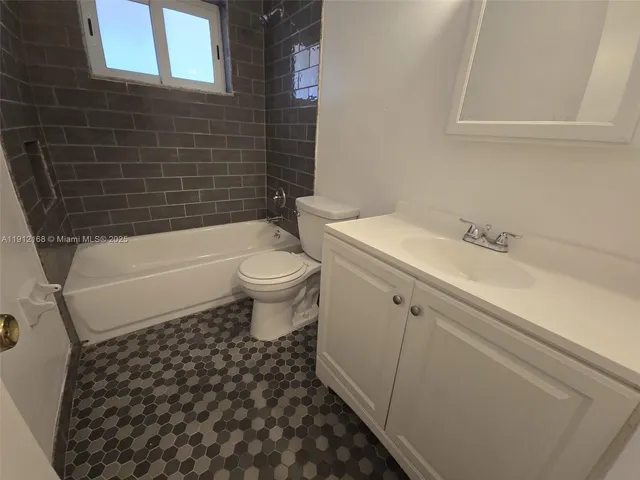 a bathroom with a toilet a sink and bathtub