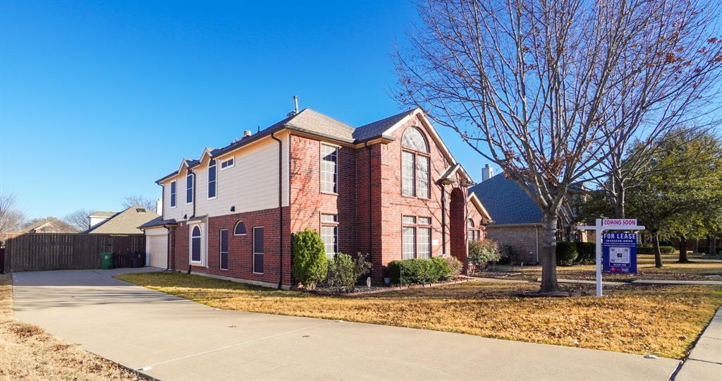 a view of a house with street and trees