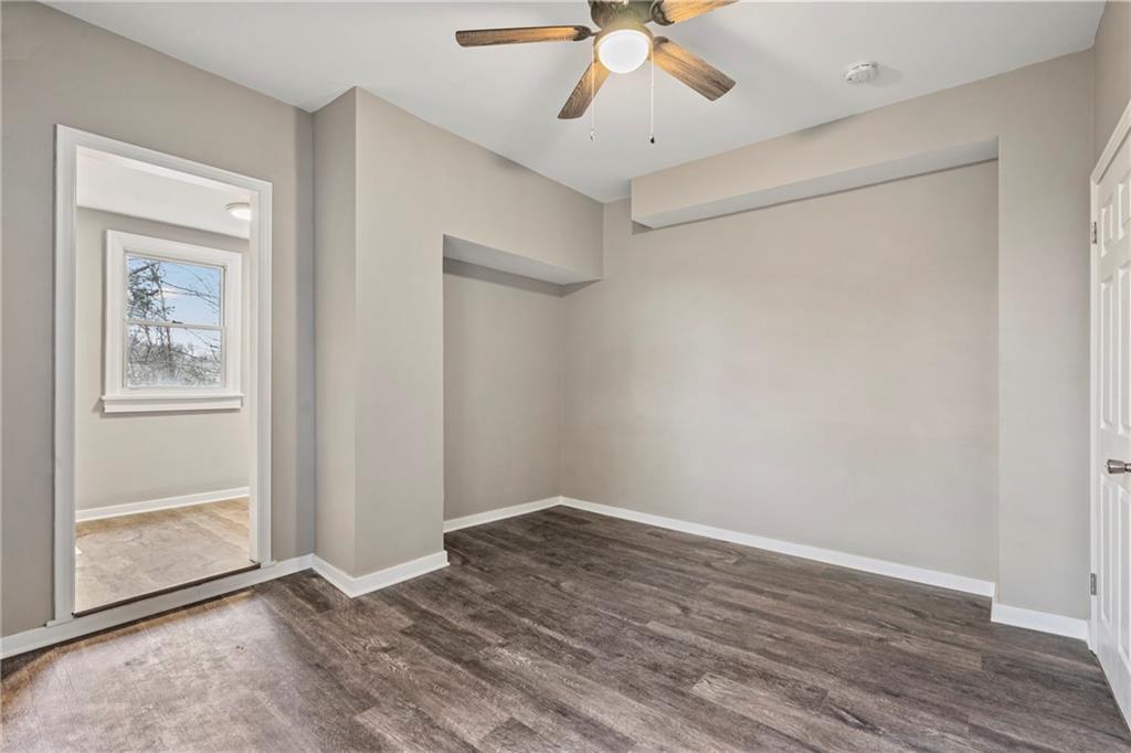 2215 Lehigh Street Pittsburgh, PA 15218 - Photo 12 of 32 an empty room with wooden floor fan and windows