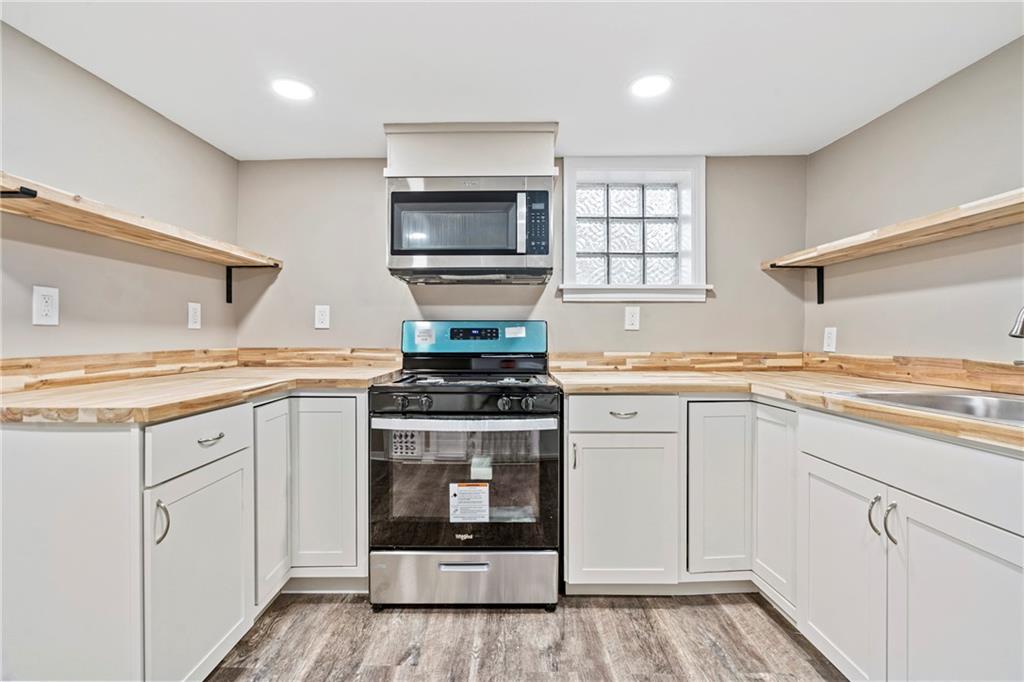2215 Lehigh Street Pittsburgh, PA 15218 - Photo 20 of 32 a kitchen with granite countertop white cabinets and white appliances