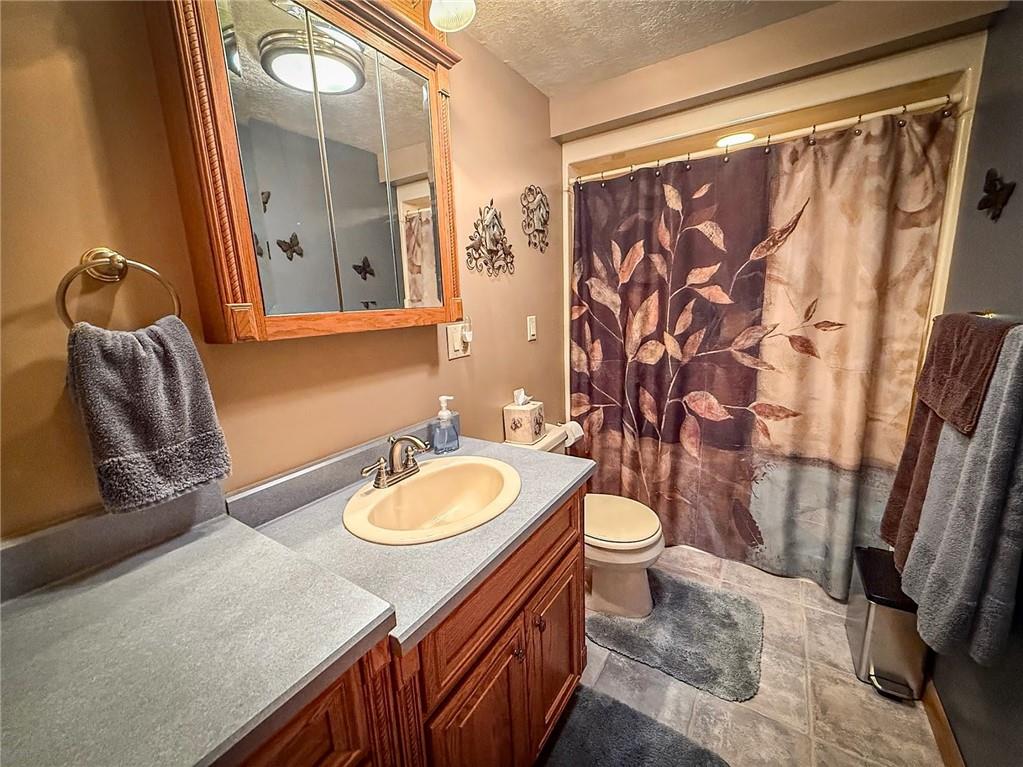 306 Chicora Road Butler, PA 16001 - Photo 15 of 30 a bathroom with a granite countertop sink and a mirror