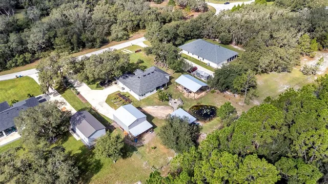 an aerial view of house with yard swimming pool and outdoor seating