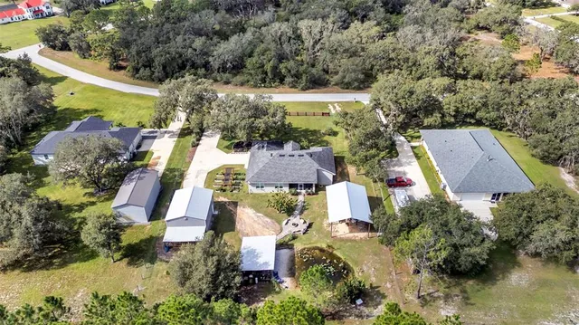 an aerial view of residential house with outdoor space and swimming pool