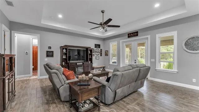 a kitchen with granite countertop a stove a sink a dining table and chairs