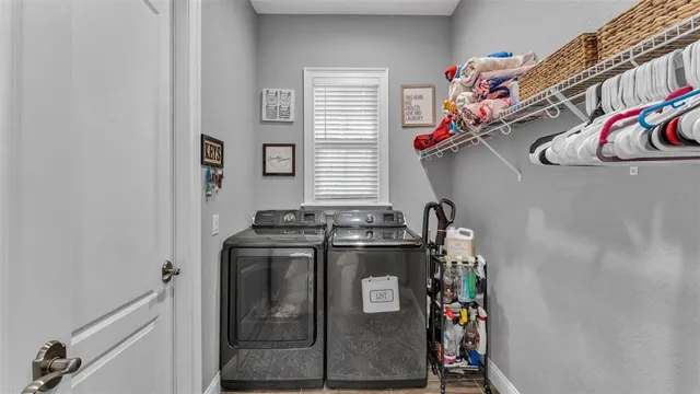 a living room with furniture kitchen view and a flat screen tv