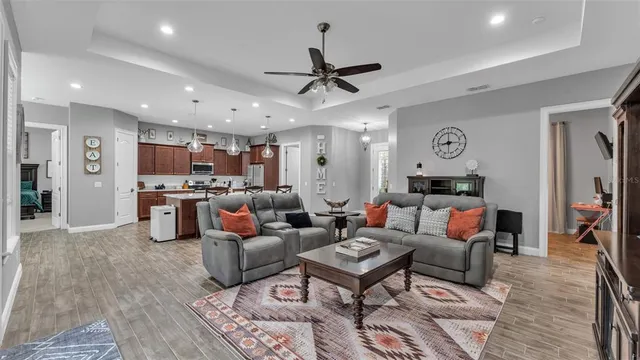 a view of a dining room with furniture and a chandelier