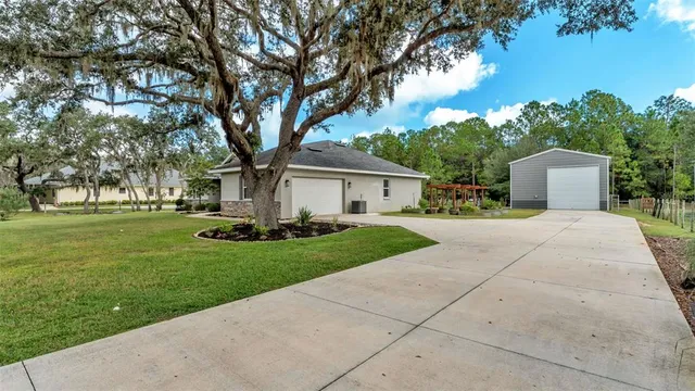 a front view of a house with a yard and trees