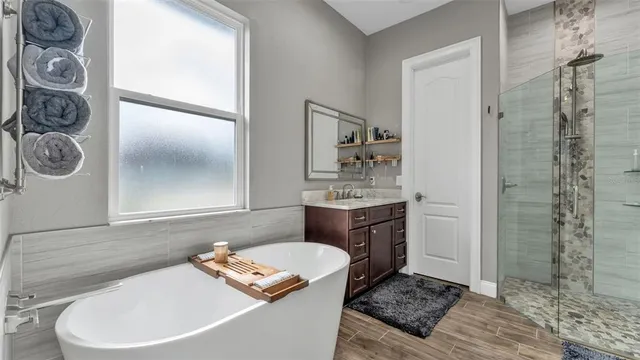 a spacious bathroom with a granite countertop sink and a mirror