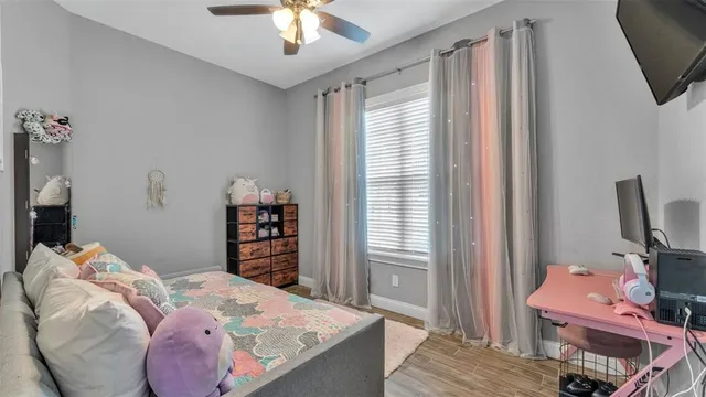 a bedroom with a bed and a television