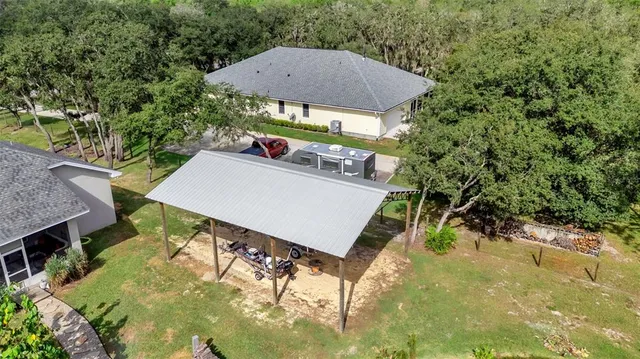 an aerial view of a house with yard swimming pool and outdoor seating
