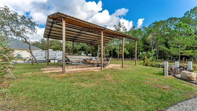 a view of a house with backyard and sitting area