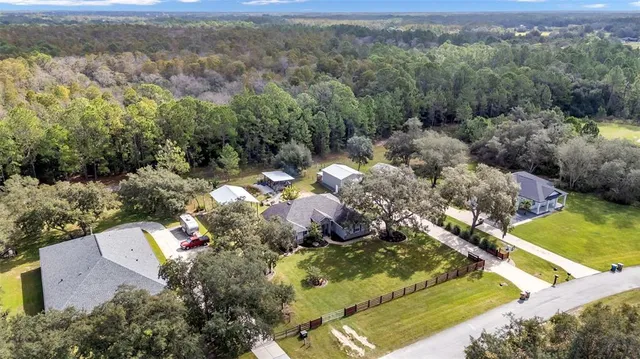an aerial view of residential houses with outdoor space