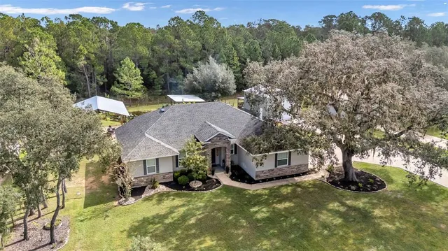 an aerial view of a house with yard tree s