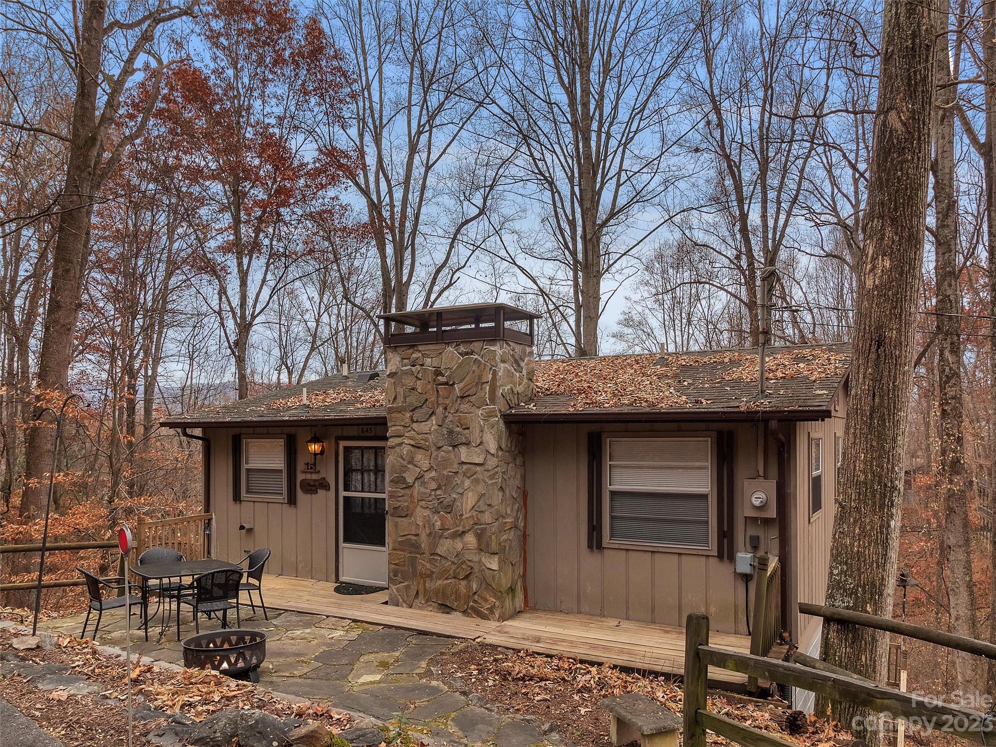 645 Mouzon Road Waynesville, NC 28785 - Photo 1 of 40 a front view of a house with yard and seating area