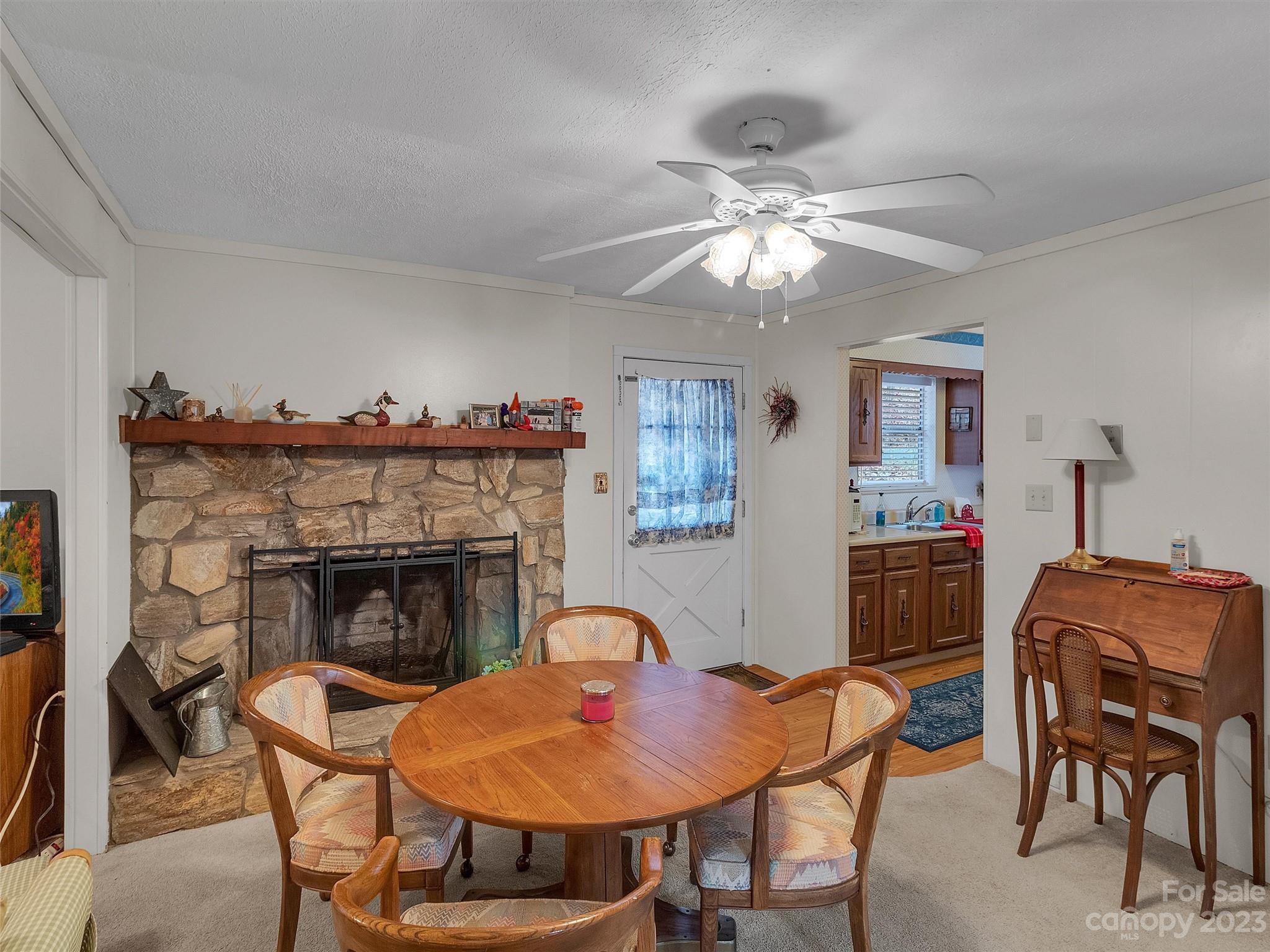 645 Mouzon Road Waynesville, NC 28785 - Photo 14 of 40 a living room with furniture a fireplace and a window