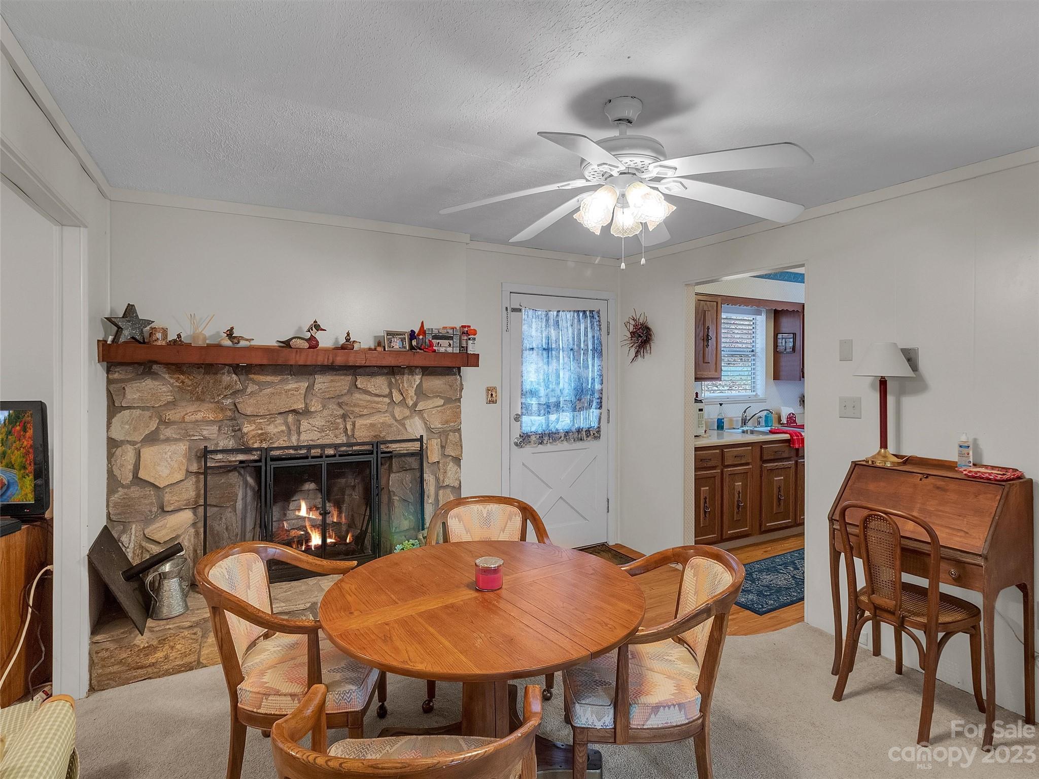 645 Mouzon Road Waynesville, NC 28785 - Photo 15 of 40 a living room with furniture a table and a fireplace