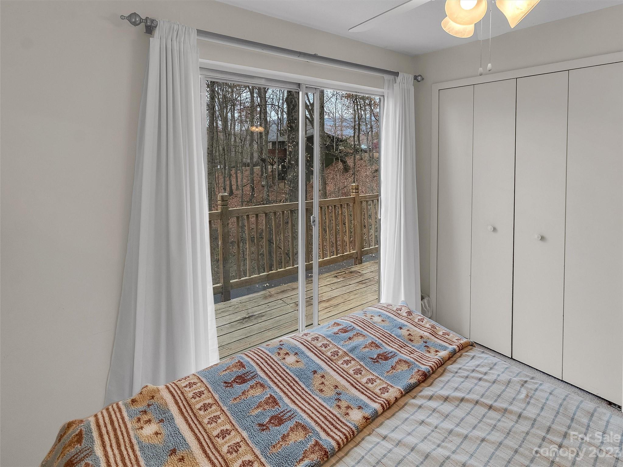 645 Mouzon Road Waynesville, NC 28785 - Photo 18 of 40 a view of a bedroom with a bed and wooden floor