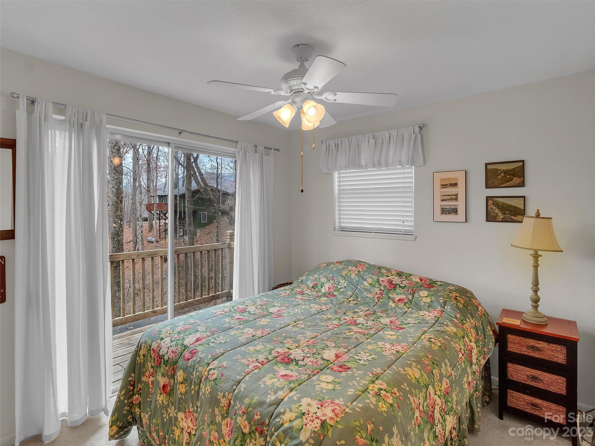 645 Mouzon Road Waynesville, NC 28785 - Photo 20 of 40 a bedroom with a bed and a chandelier