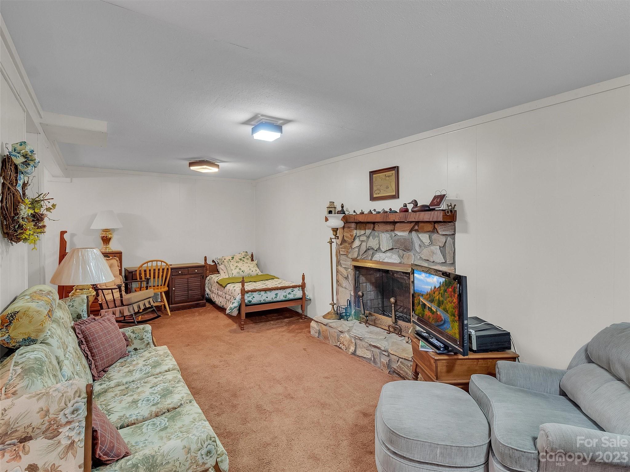 645 Mouzon Road Waynesville, NC 28785 - Photo 27 of 40 a living room with furniture and a fireplace