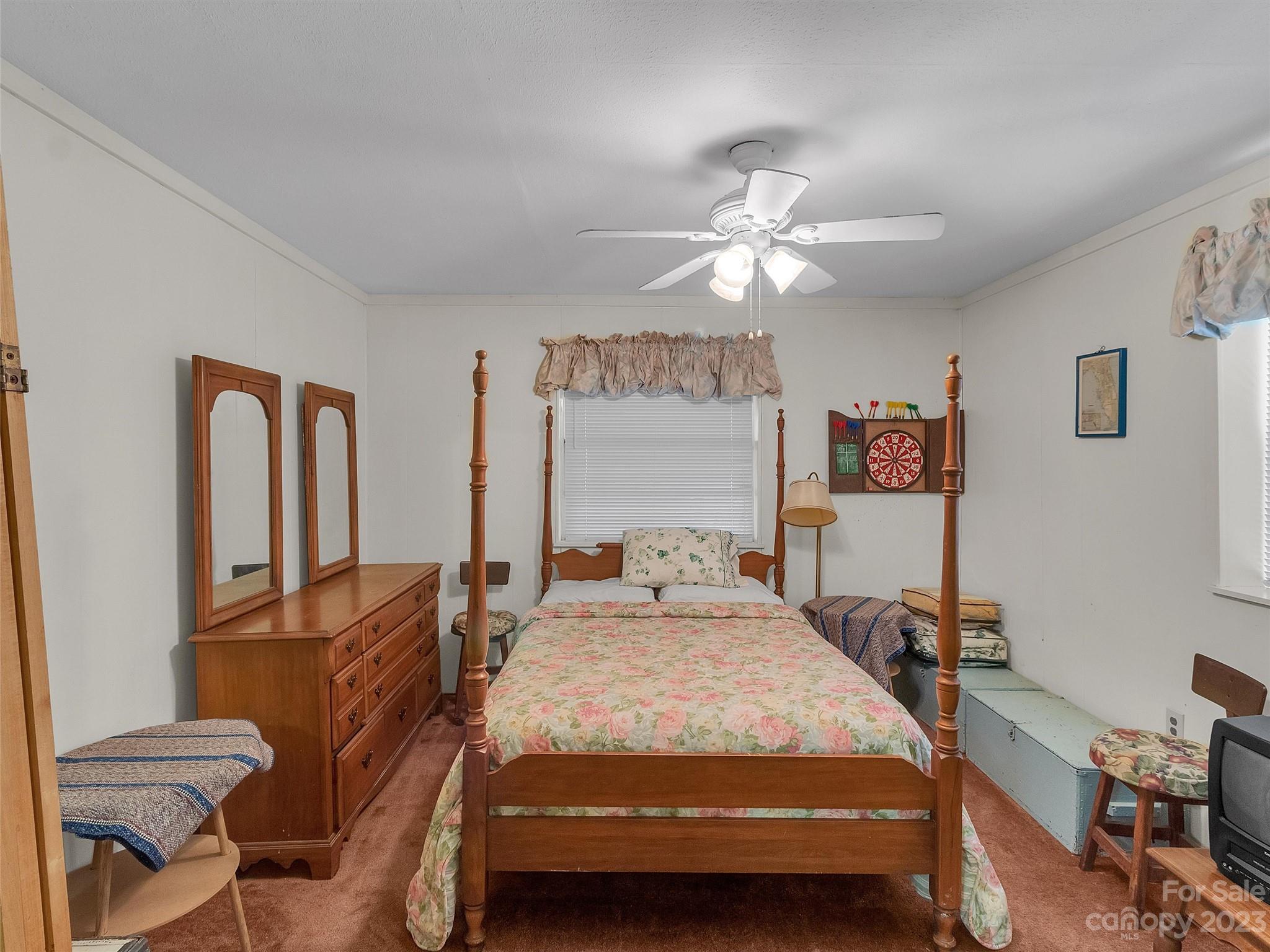 645 Mouzon Road Waynesville, NC 28785 - Photo 29 of 40 a bedroom with a bed window and chair