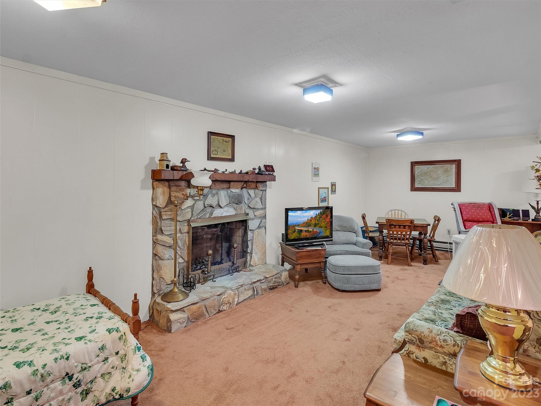 645 Mouzon Road Waynesville, NC 28785 - Photo 30 of 40 a bedroom with furniture and a fireplace