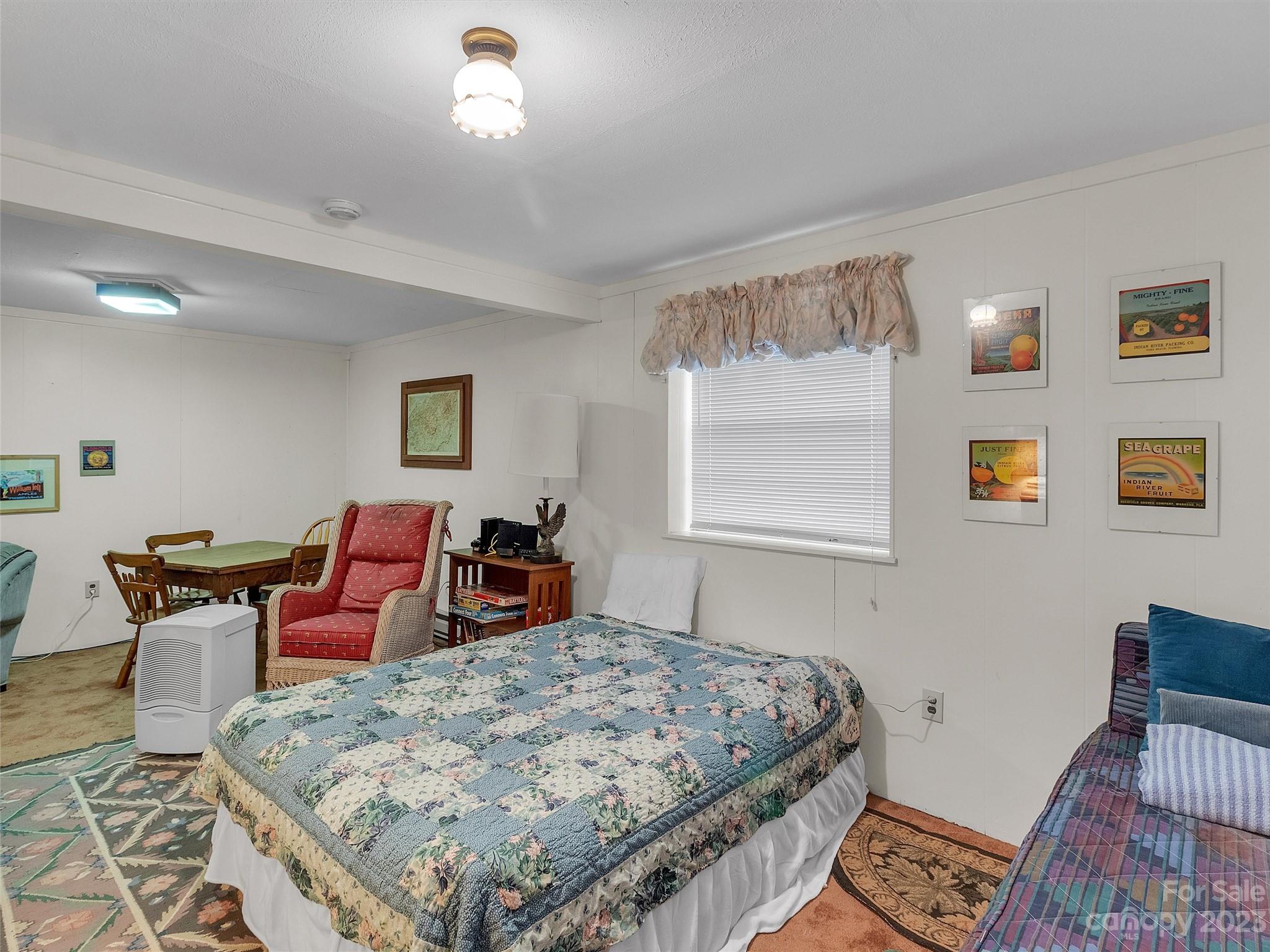 645 Mouzon Road Waynesville, NC 28785 - Photo 32 of 40 a bed room with a bed and wooden floor