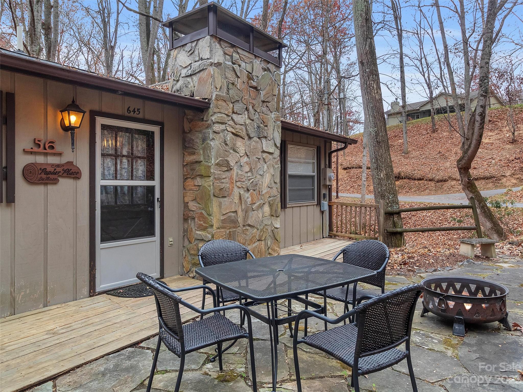 645 Mouzon Road Waynesville, NC 28785 - Photo 4 of 40 a backyard of a house with barbeque oven table and chairs