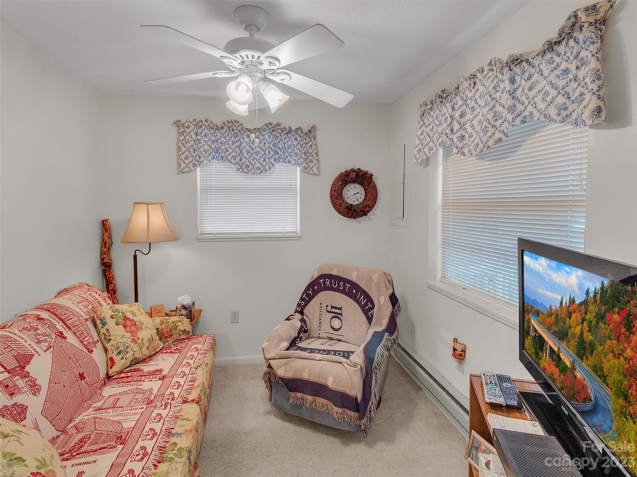 645 Mouzon Road Waynesville, NC 28785 - Photo 8 of 40 a bedroom with a bed and a chandelier