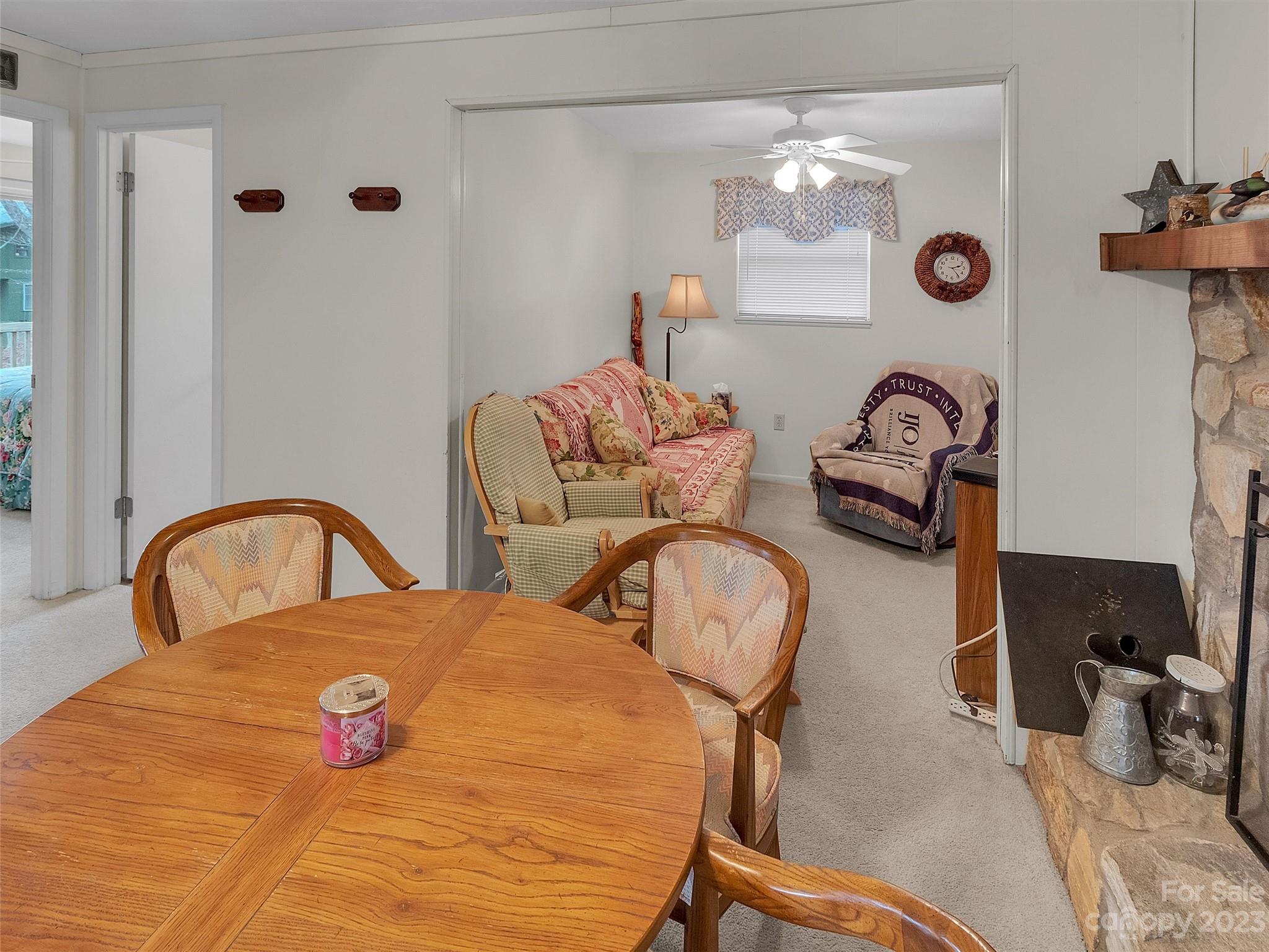 645 Mouzon Road Waynesville, NC 28785 - Photo 10 of 40 a bedroom with bed and a chandelier