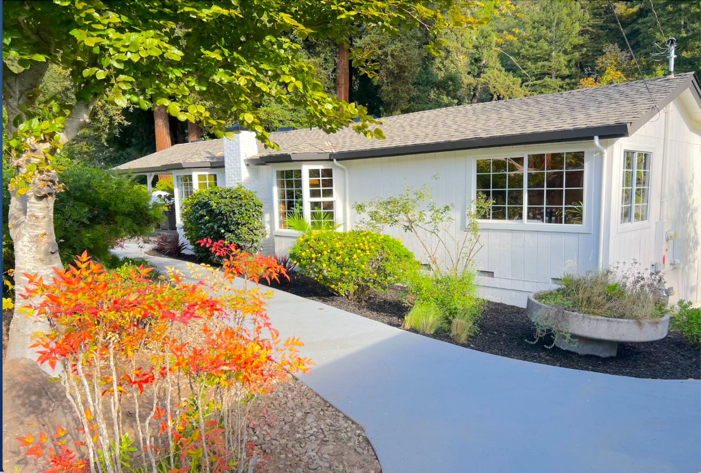 a front view of a house with a yard and fountain